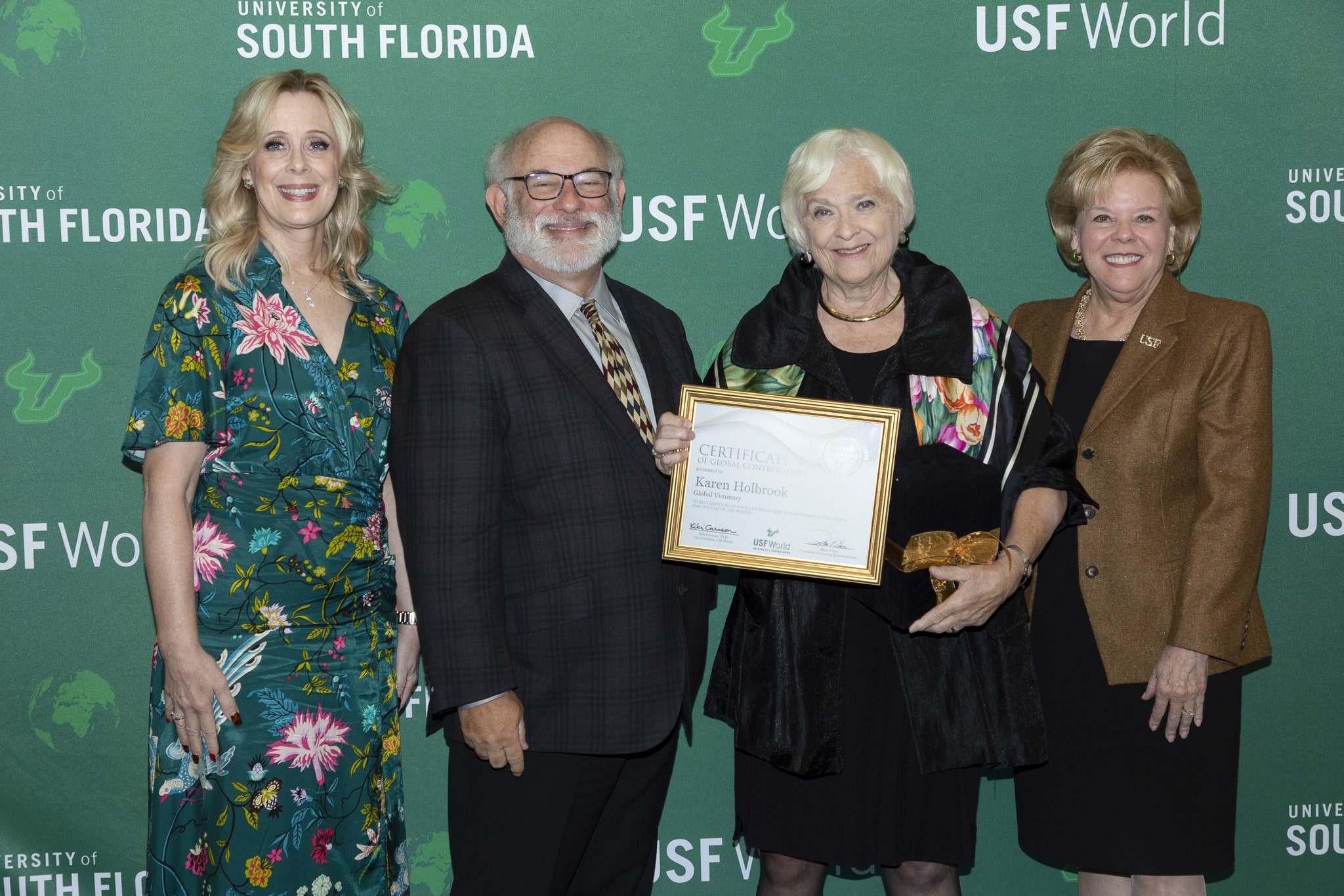 Holbrook receiving award from USF World