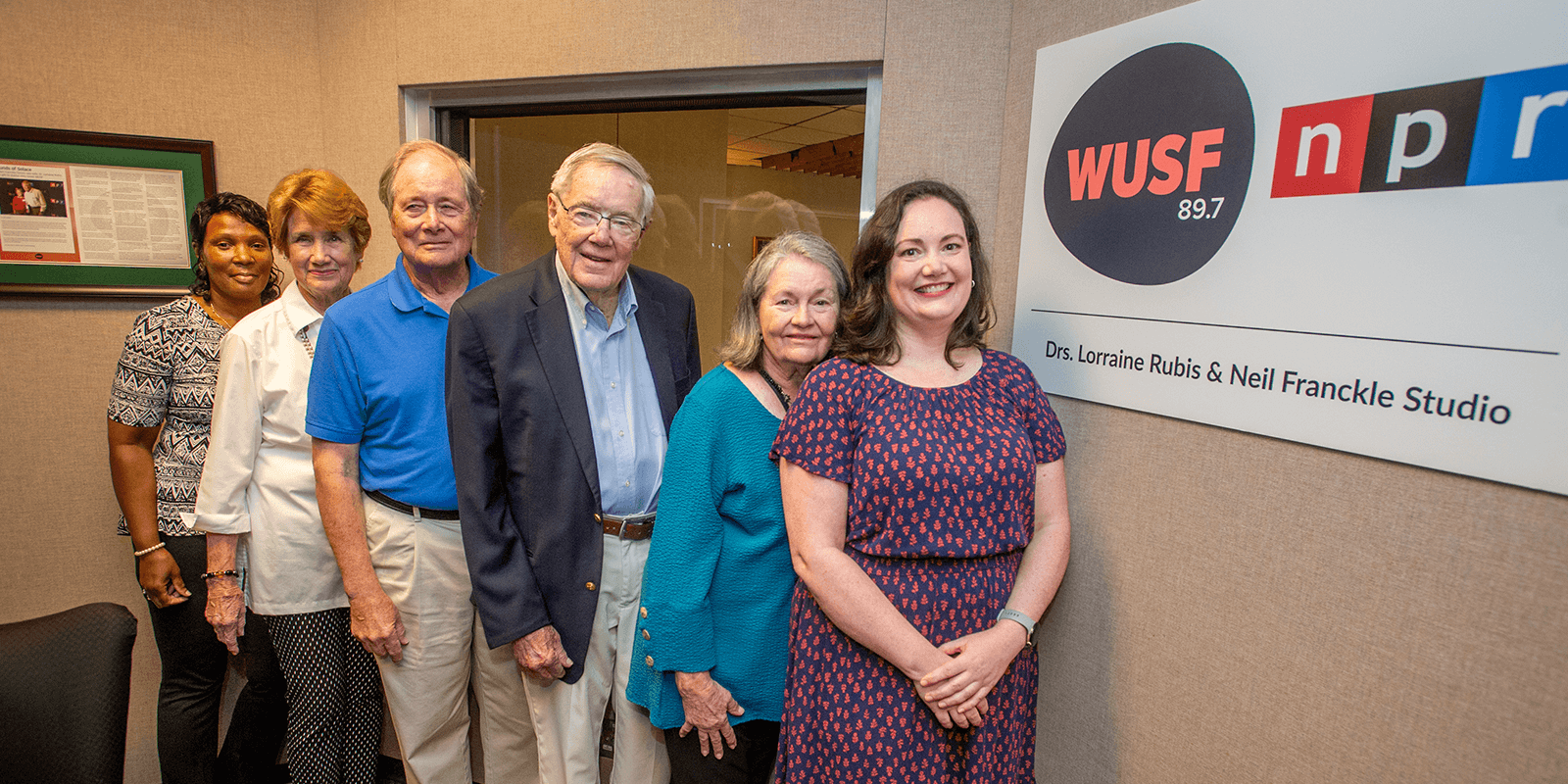 Dr. Neil Franckle and and others pose for a photo outside newly named studio at WUSF