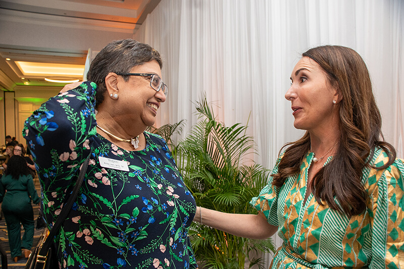 WLP Executive Director Lauren Gstalder congratulated surprise Green and Gold Award recipient Anila Jain after the Symposium wrapped.