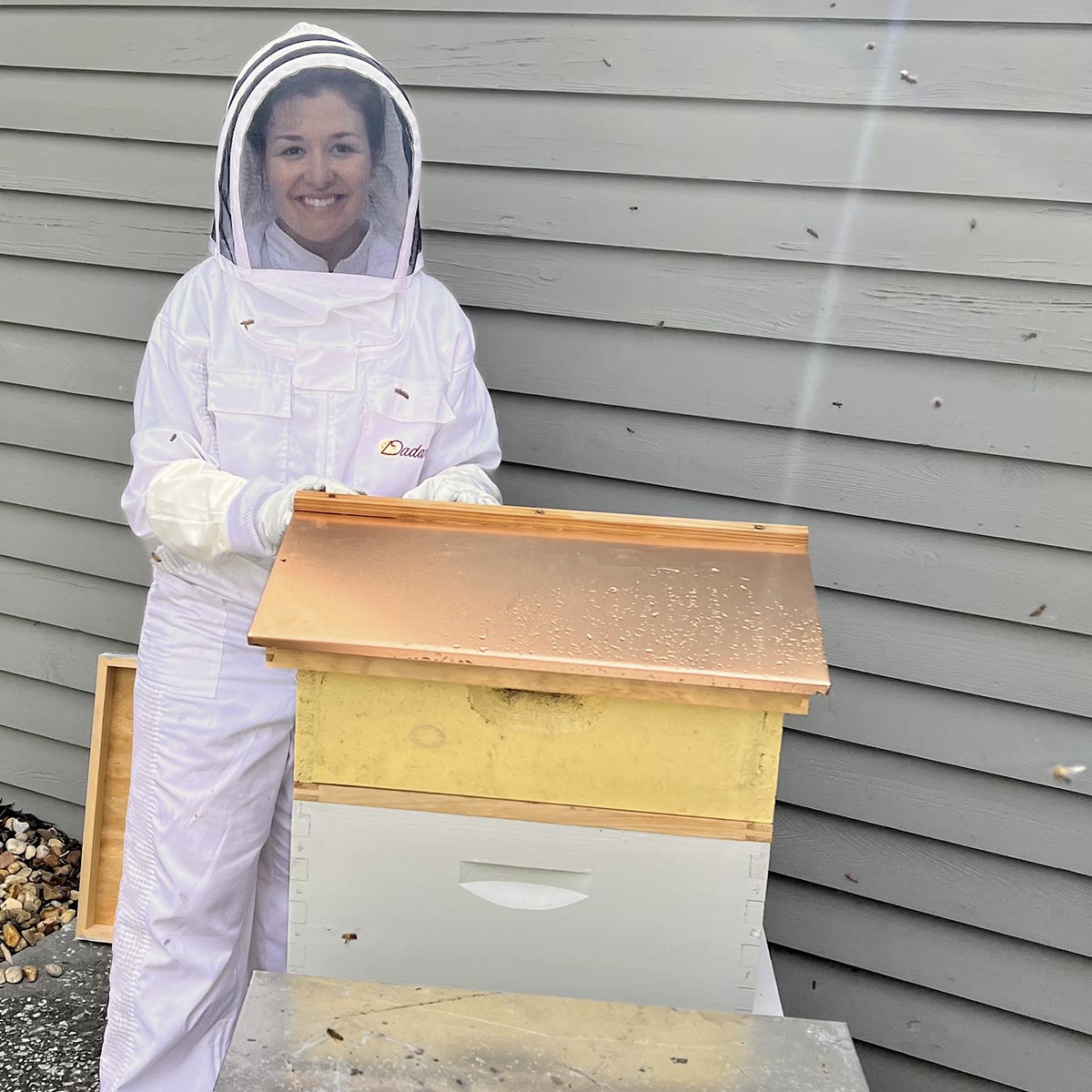 Ashley Messer tends their urban beehive.